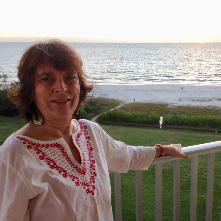 Jeri Diehl-Cusack stands in front of the water.