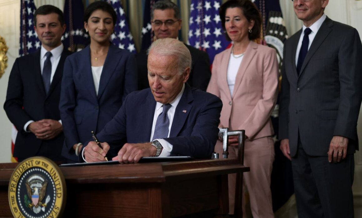 President Joe Biden signs executive order on “promoting competition in the American economy” as (L-R) Secretary of Transportation Pete Buttigieg, FTC Chair Lina Khan, and Secretary of Health and Human Services Xavier Becerra look on during an event at the State Dining Room of the White House on July 9, 2021. (Photo by Alex Wong/Getty Images)