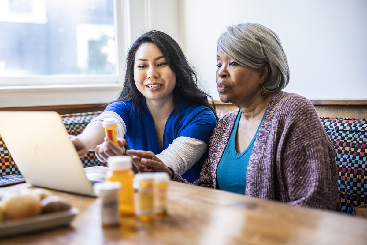 Senior woman having in-home consultation with nurse